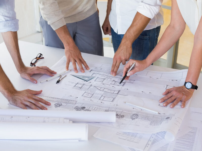 Casual architecture team working together at desk in the office